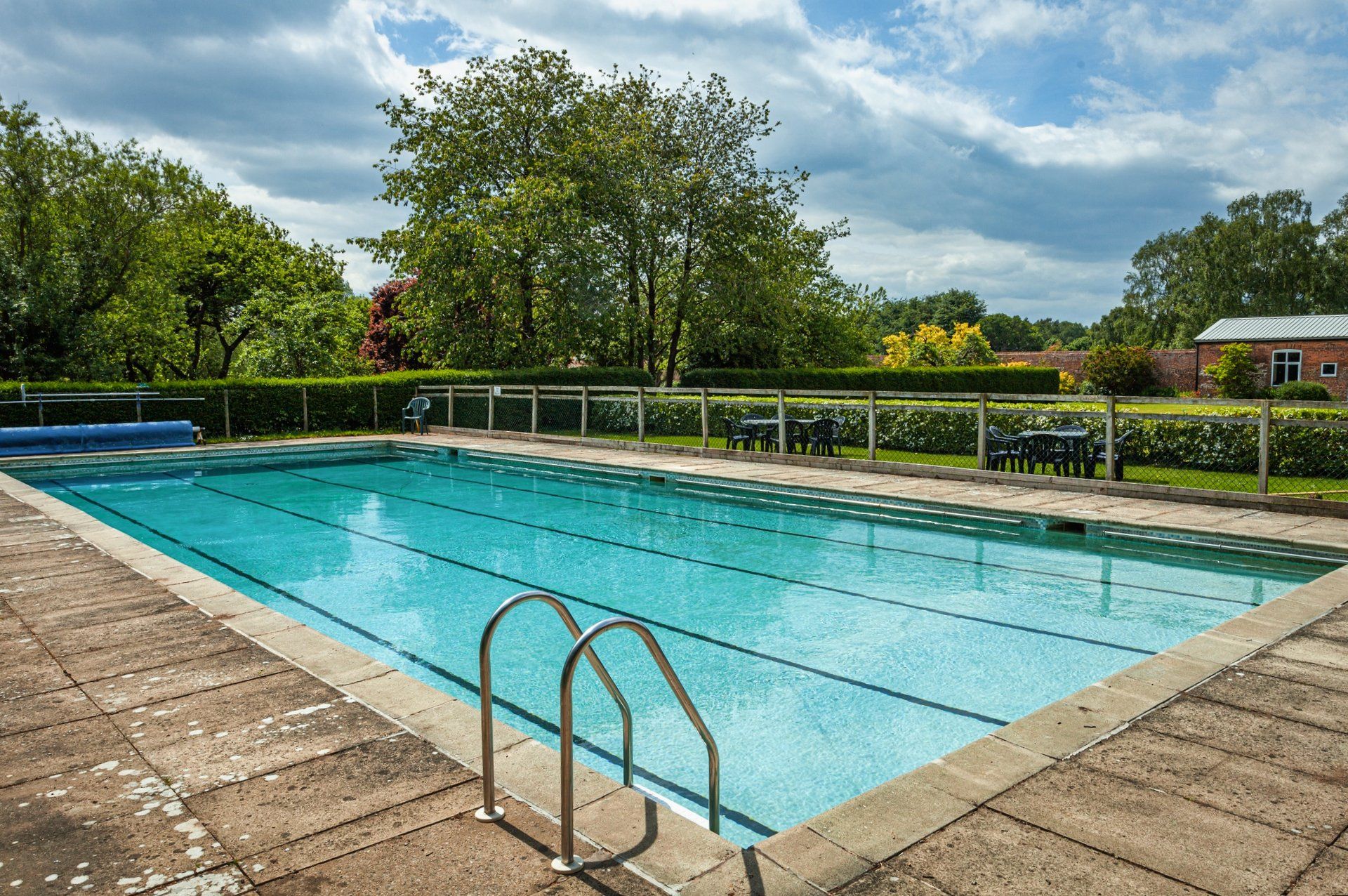 A large swimming pool with stairs leading to it