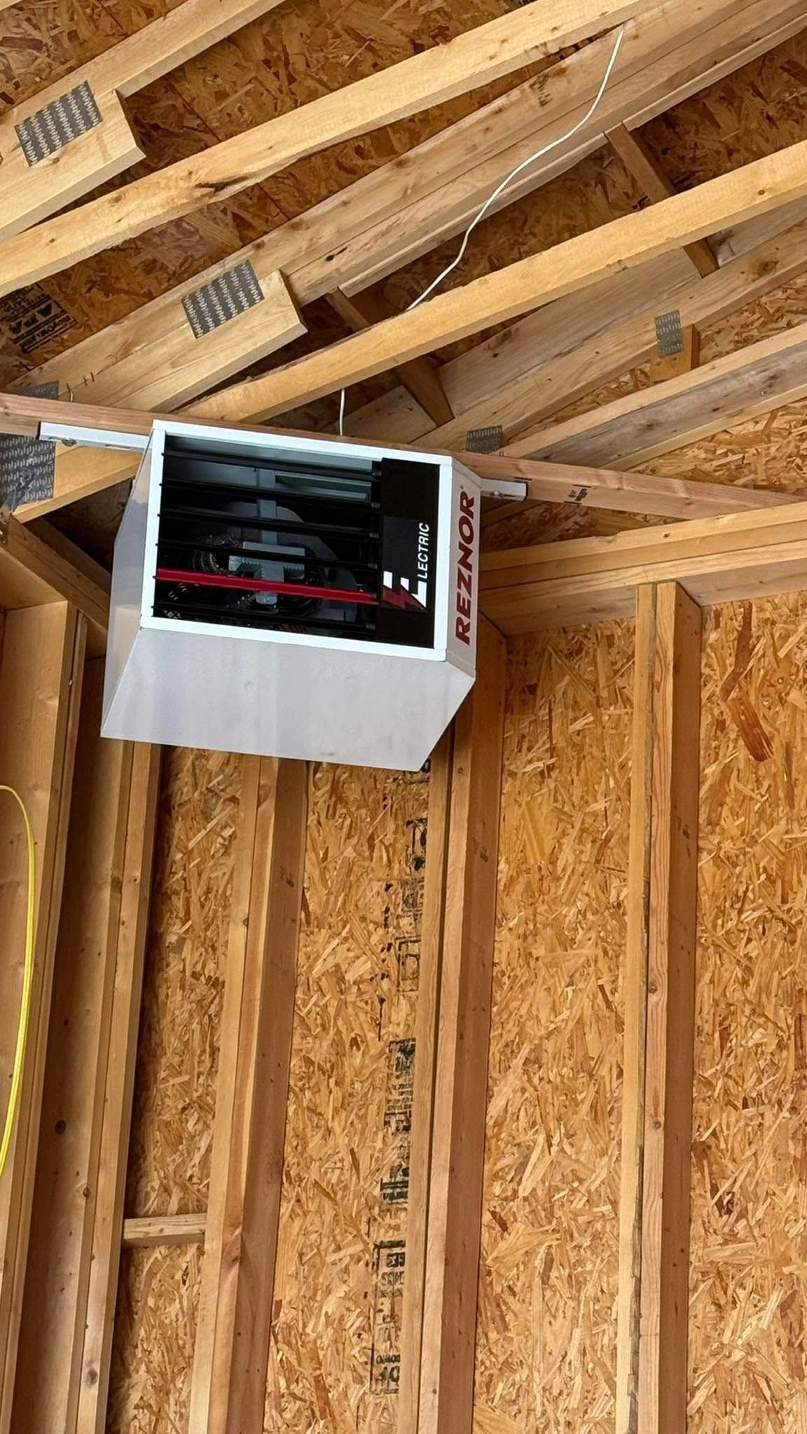 Groulx Mechanical - A box is hanging from the ceiling of a house under construction.