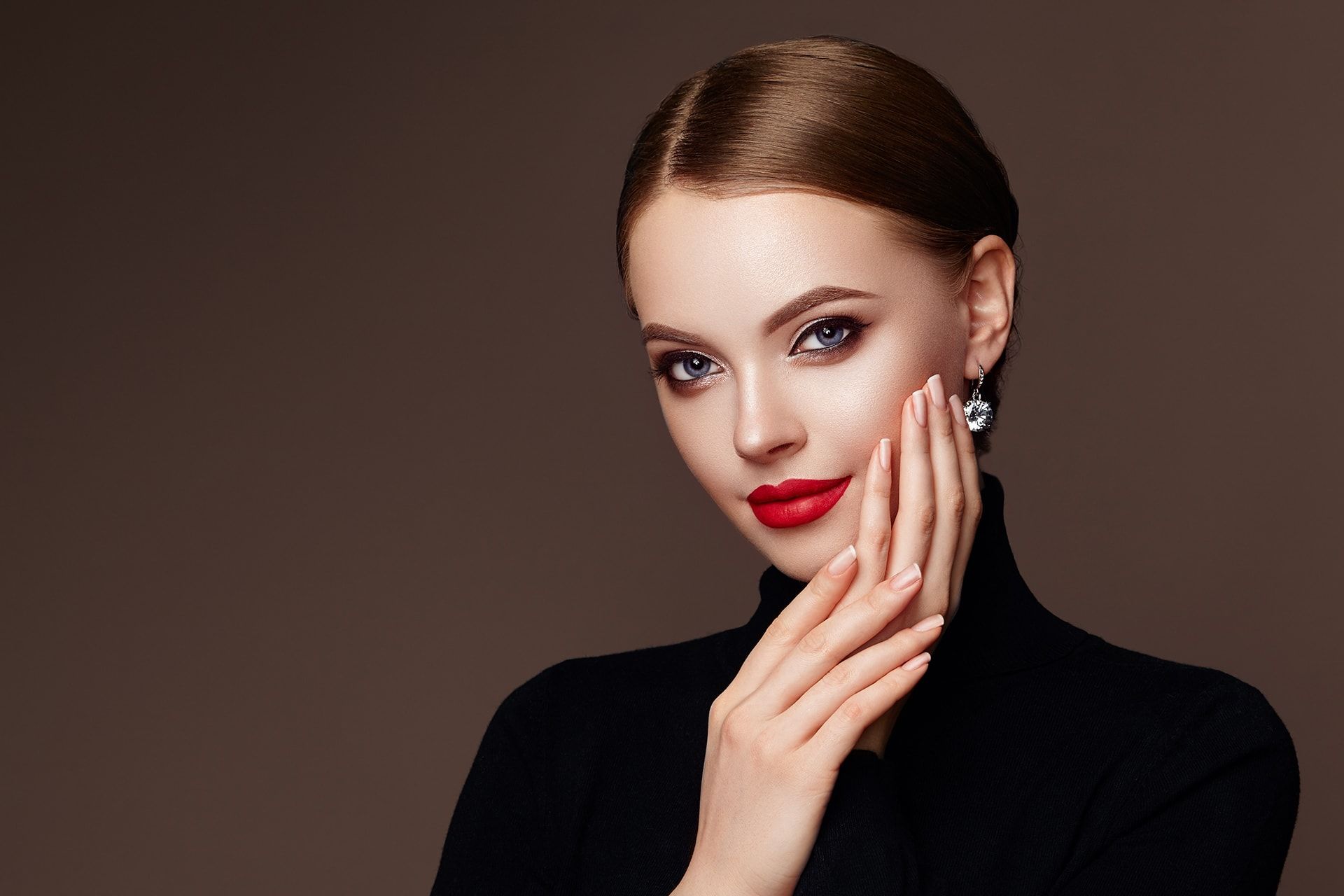 The woman is wearing a black turtleneck and red lipstick.