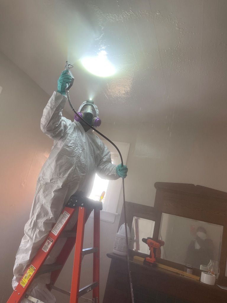 Fire-damaged interior with caution tape. Charred walls, exposed beams, and a staircase - Restoration Services by HRS.