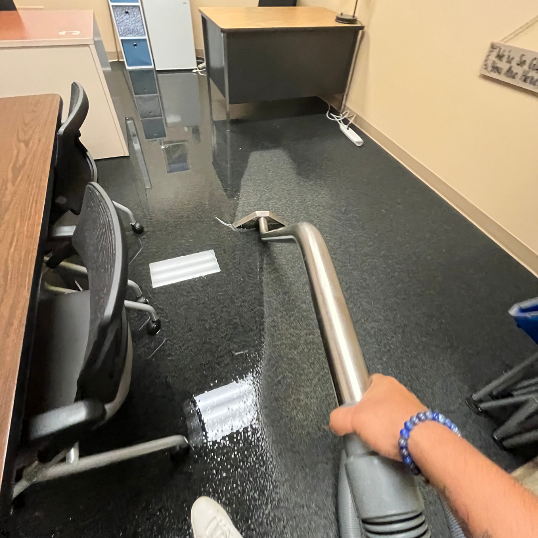 HRS Technician performing water extraction on flooded commercial office floor in Denver