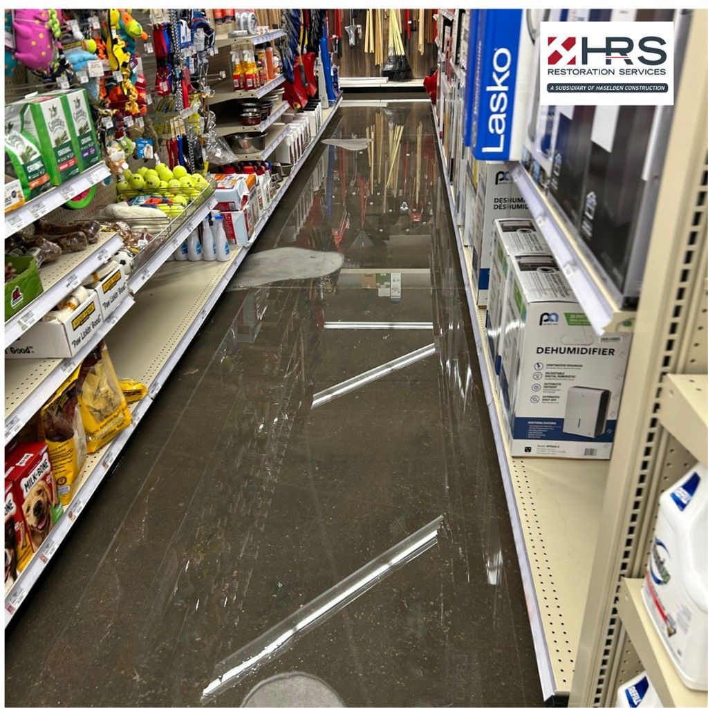Flood cleanup and standing water damage inside a retail aisle in Meridian, CO