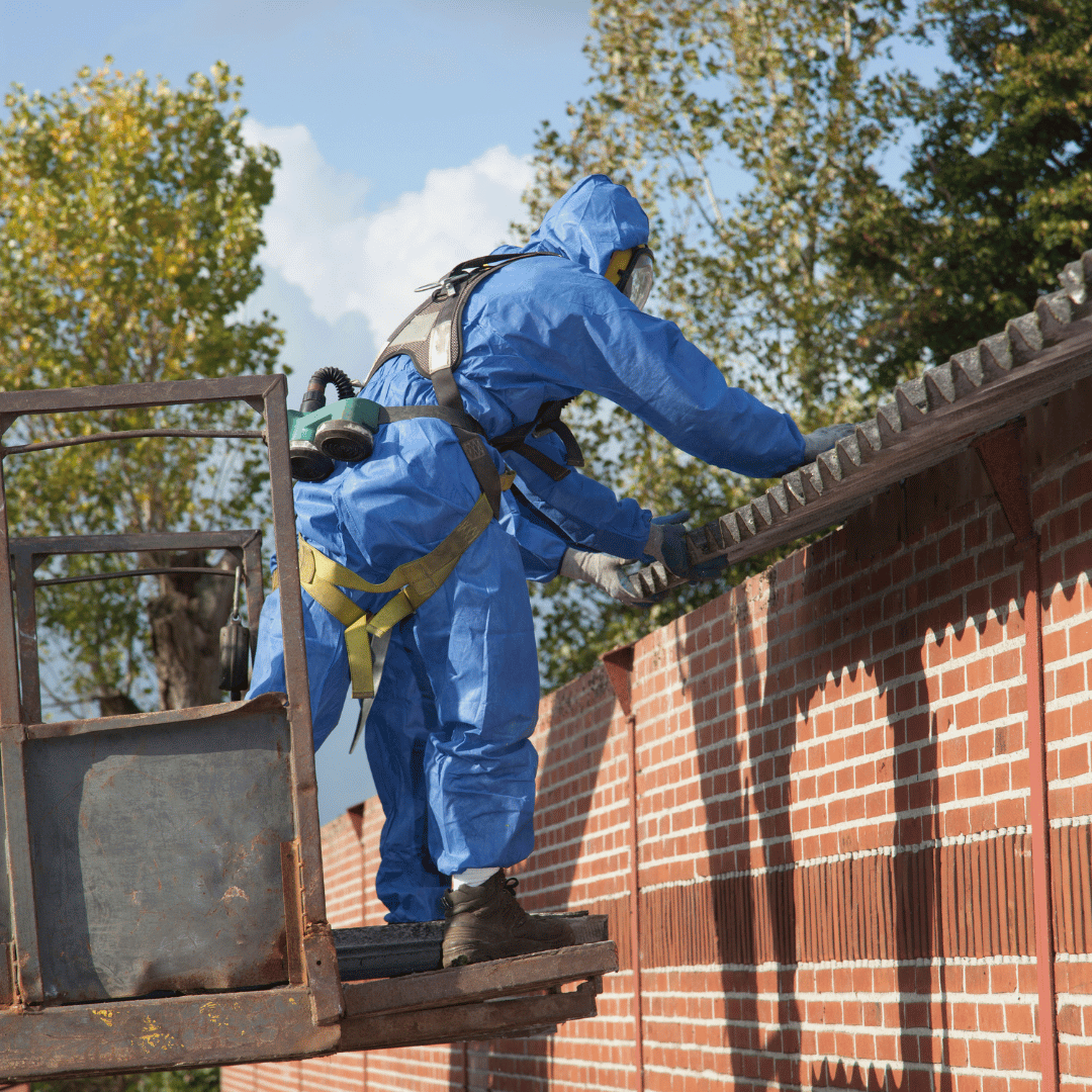 Industrial asbestos abatement in Denver, Colorado. A technician in a blue hazmat suit and full-face respirator works within a contained area, demonstrating HRS's expertise in commercial and industrial hazardous material removal.