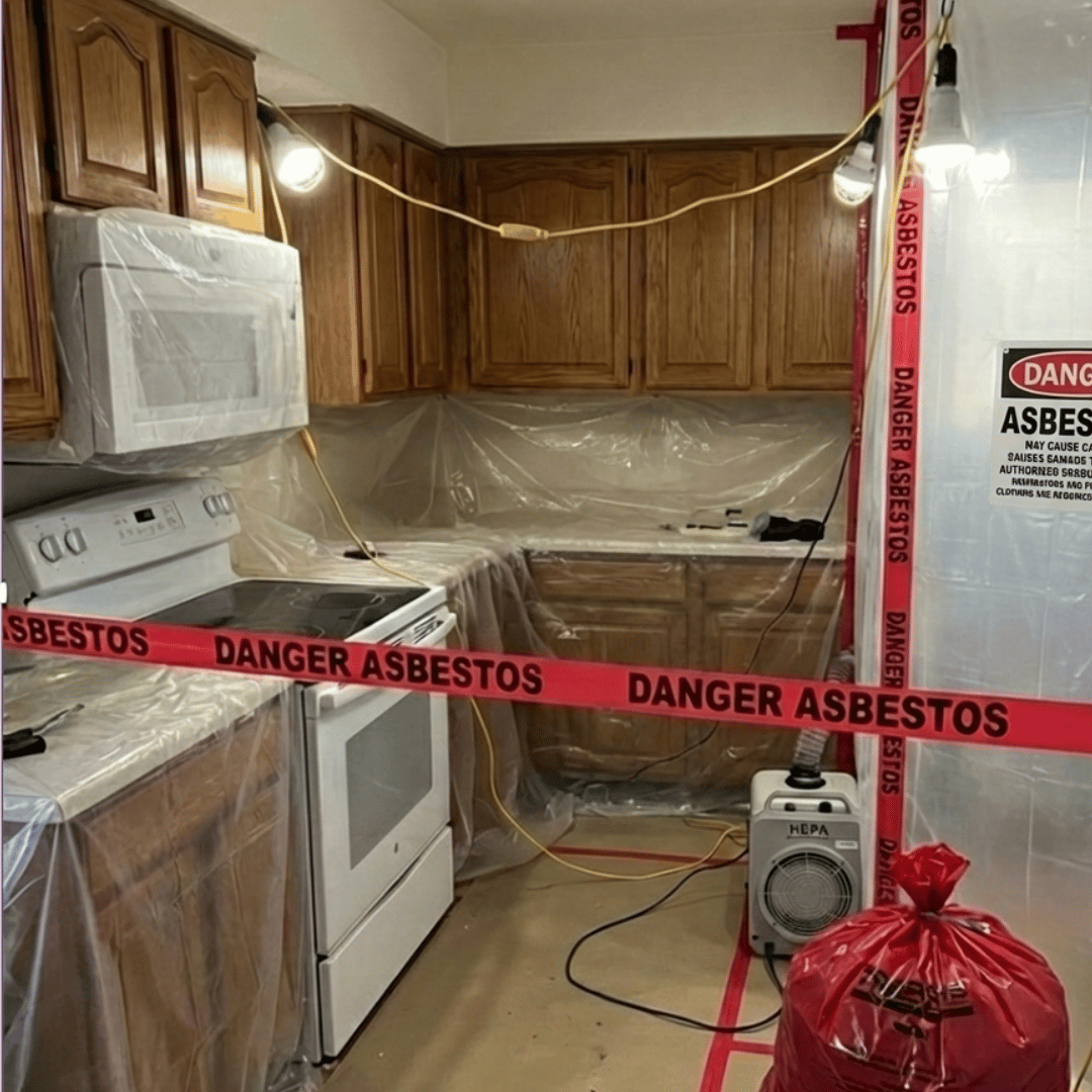 Kitchen asbestos abatement setup in Lakewood, CO showing sealed containment, HEPA filtration, and safety barriers during removal by HRS Restoration Services.