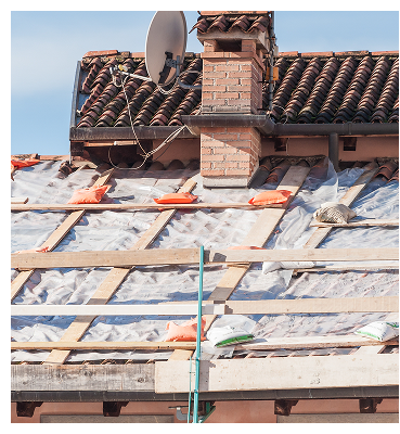 Roof under construction with visible wooden supports, covering, chimney, and satellite dish.
