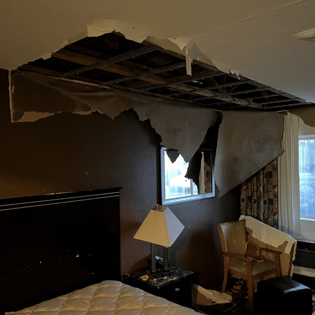 Water damage in Lakewood, CO causing ceiling collapse and exposed framing after prolonged moisture intrusion.