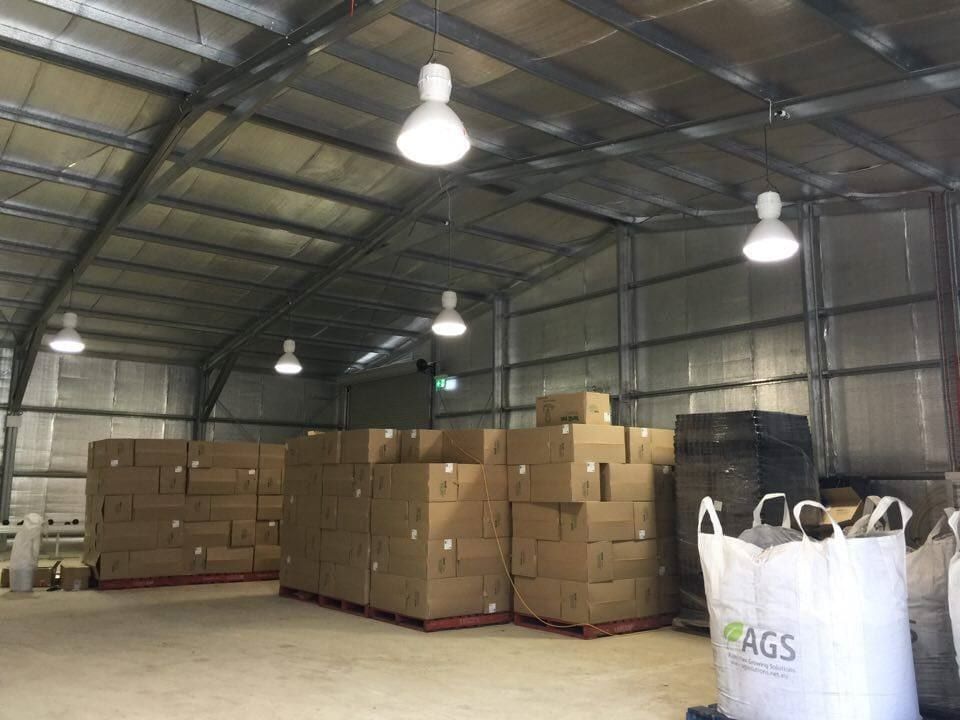 A Large Warehouse Filled with Lots of Boxes and Bags — ShedPro Constructions in Darawank, NSW