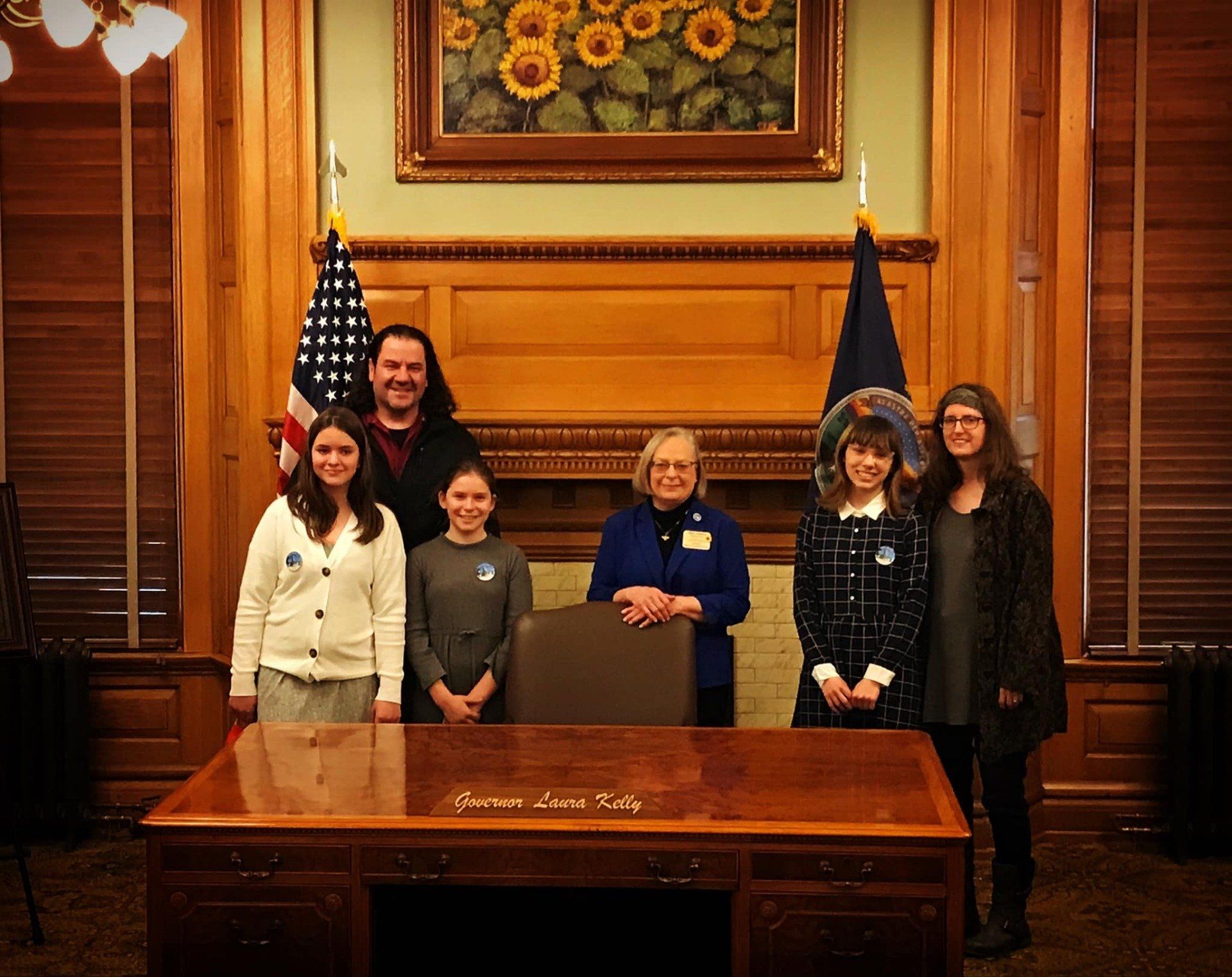 Legislative Pages, their parents and Rep. Curtis at the Governor's Ceremonial Desk.