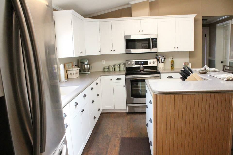 a kitchen with stainless steel appliances and white cabinets