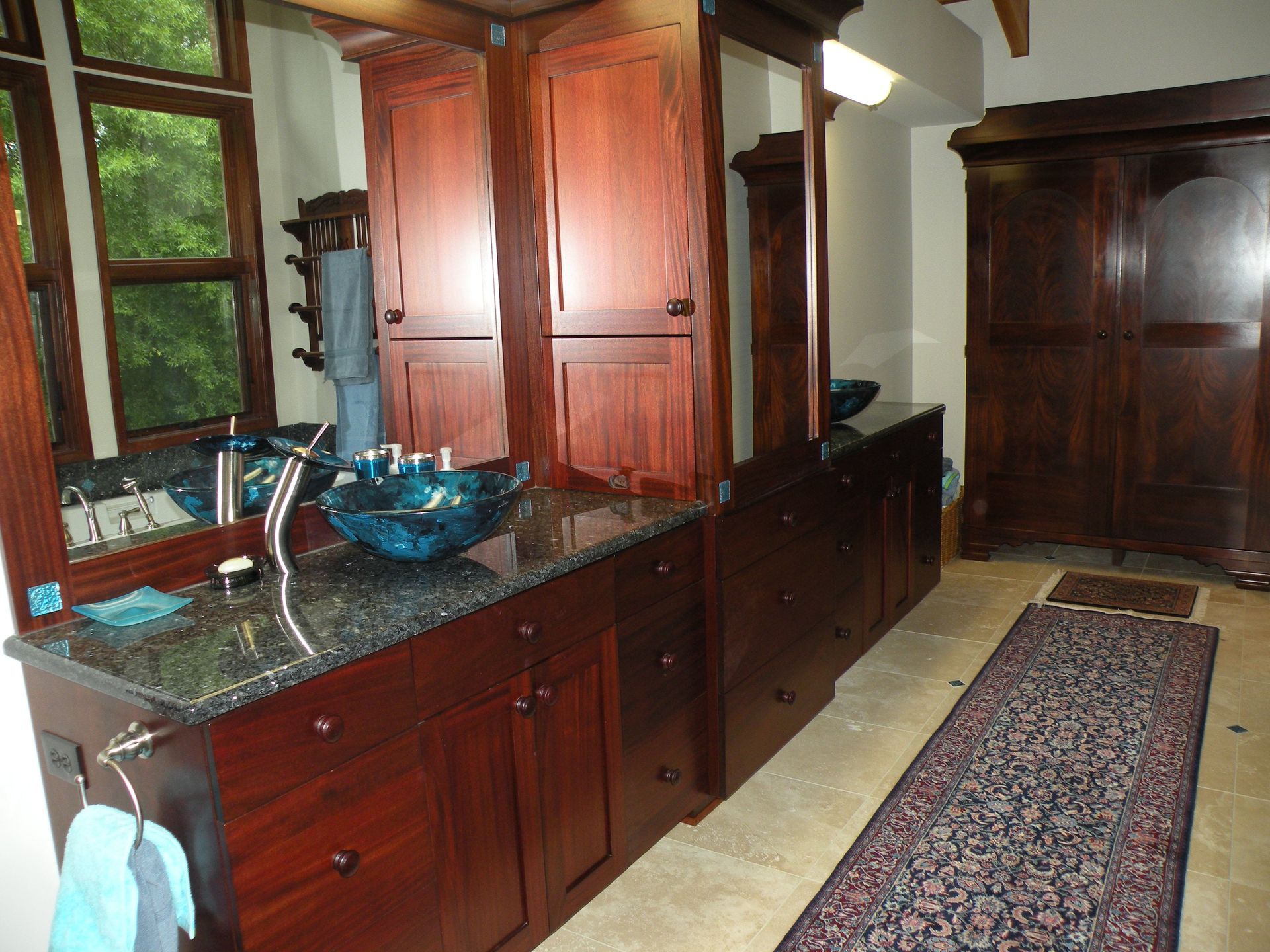 a living room with white shelves and a rug