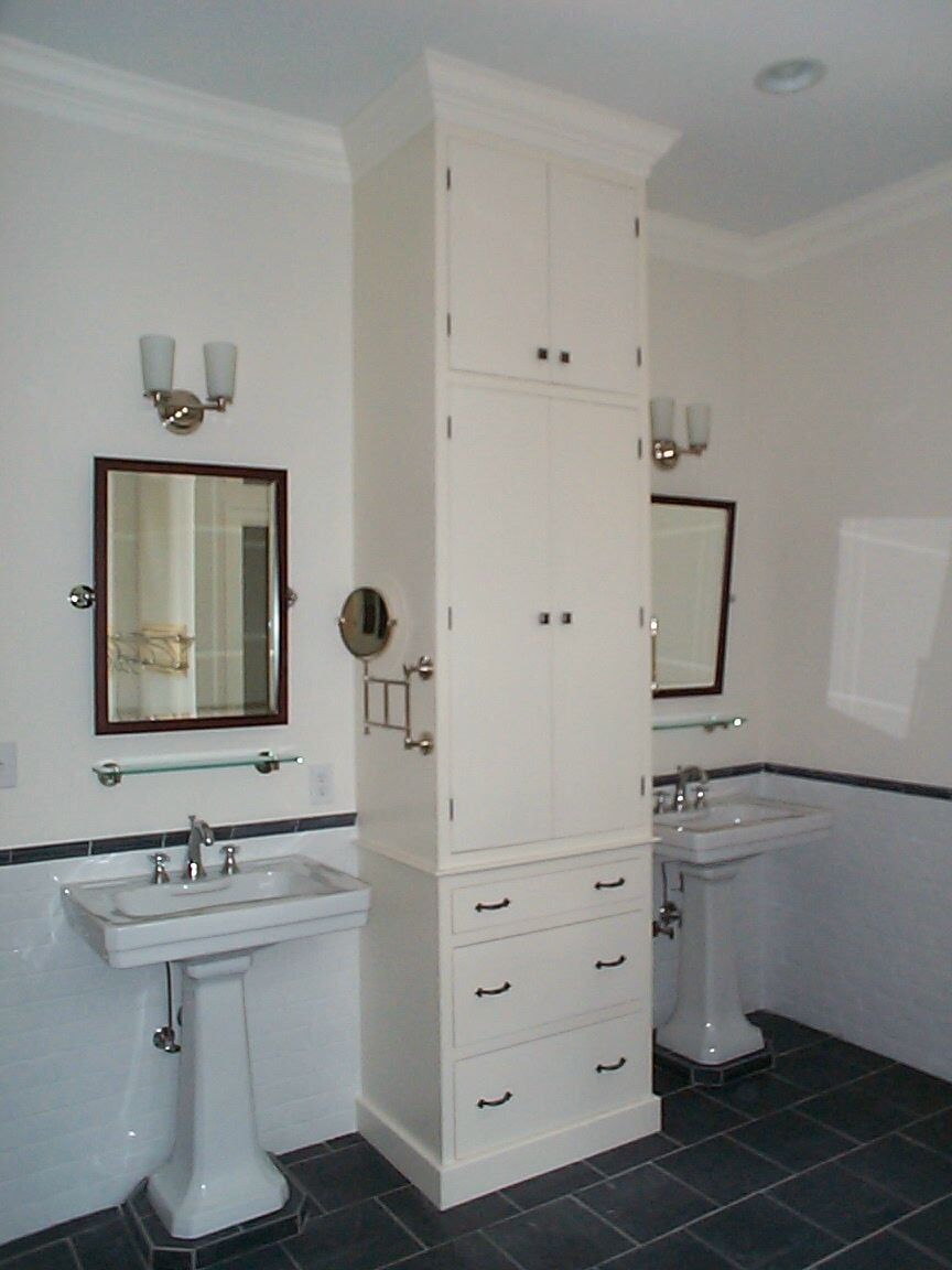 a bathroom with two sinks and a mirror