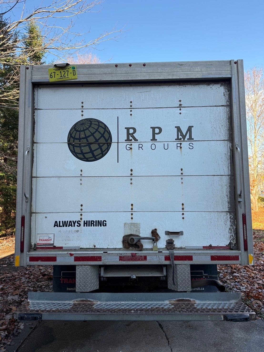 A man is holding a pair of gauges in front of an air conditioner.