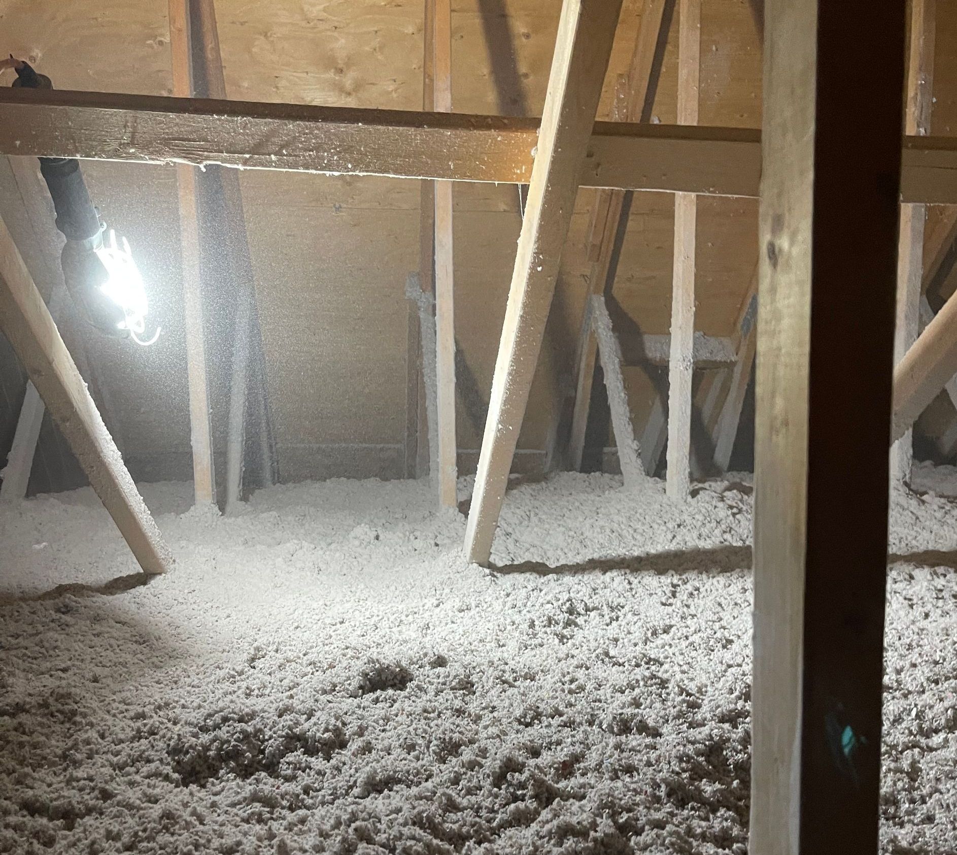 A man is working on the attic of a house.