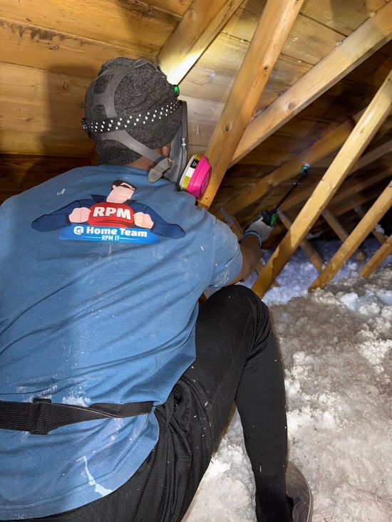 A man is measuring the ceiling with a tape measure.