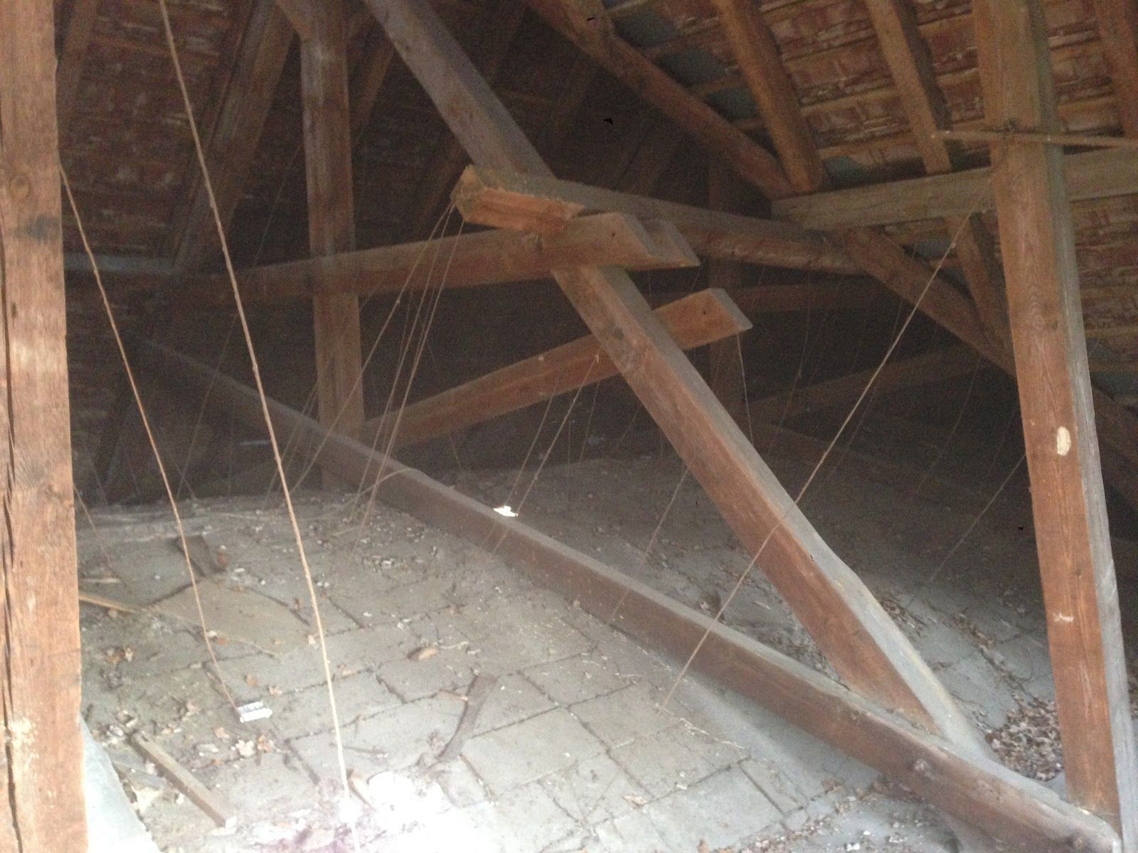 The inside of a building with a lot of wooden beams