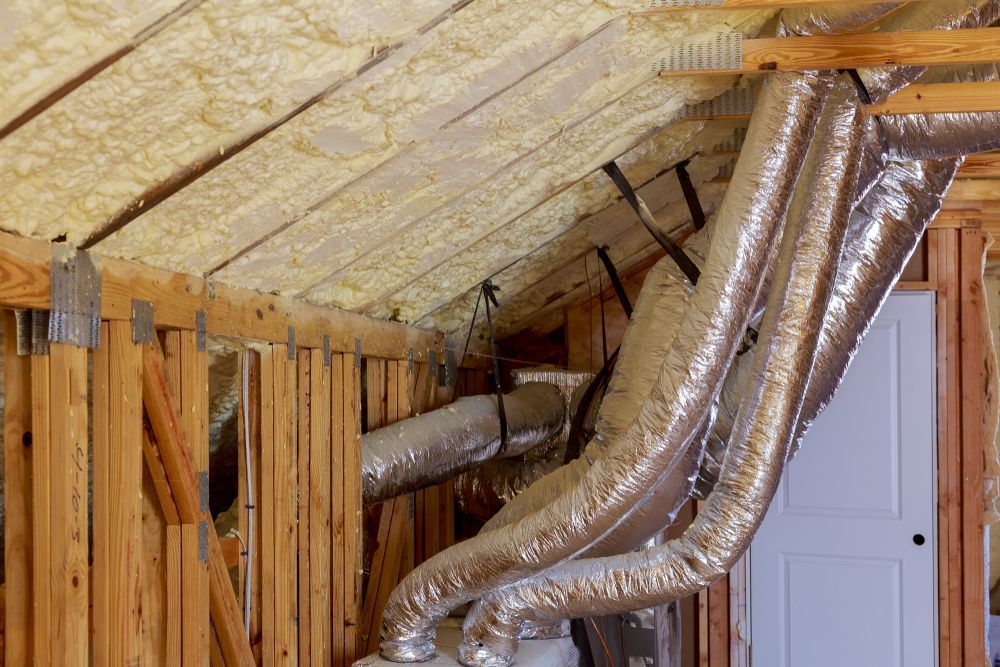A room with a lot of pipes hanging from the ceiling.