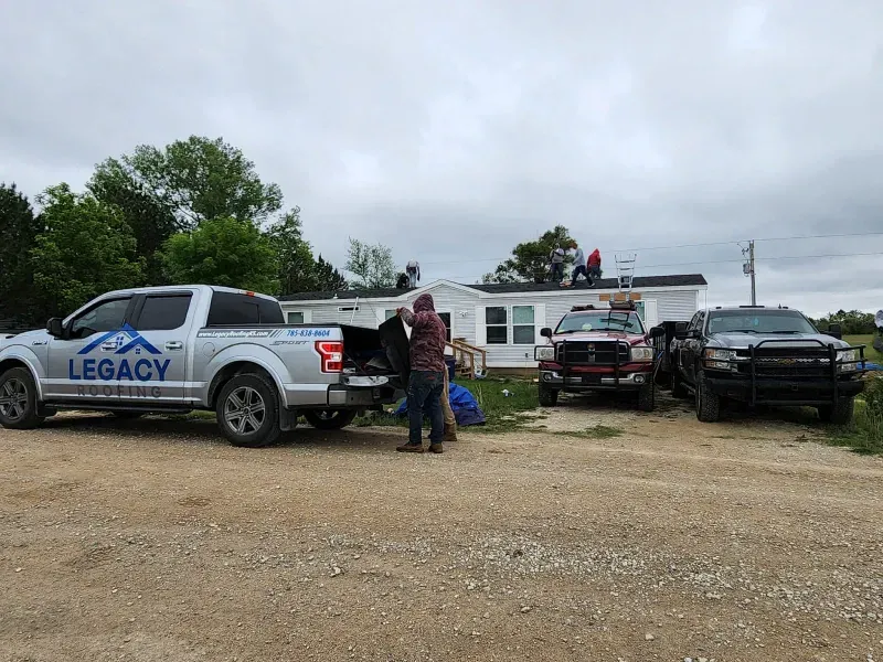 A group of trucks are parked in front of a house.