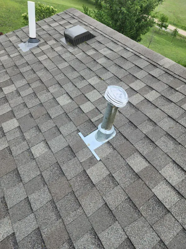 A close up of a roof with a vent on it.