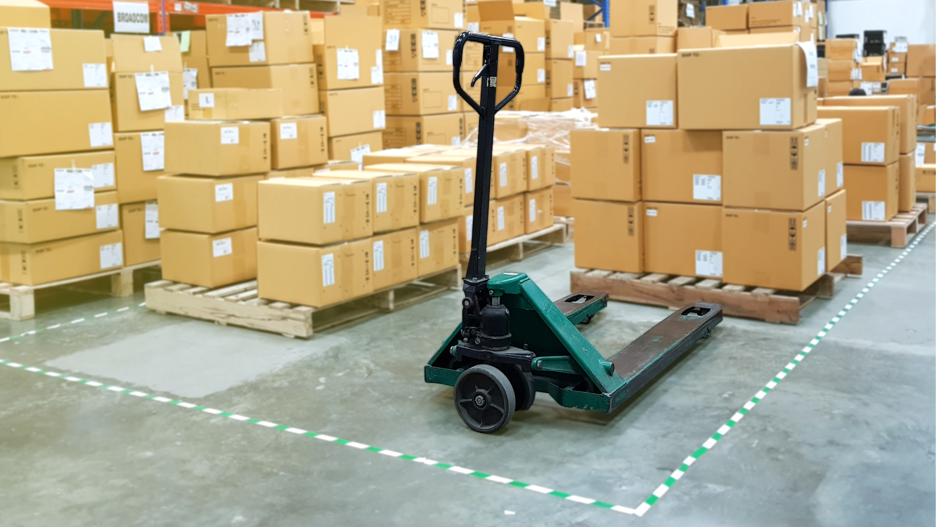 A delivery man is handing a stack of boxes to a woman.