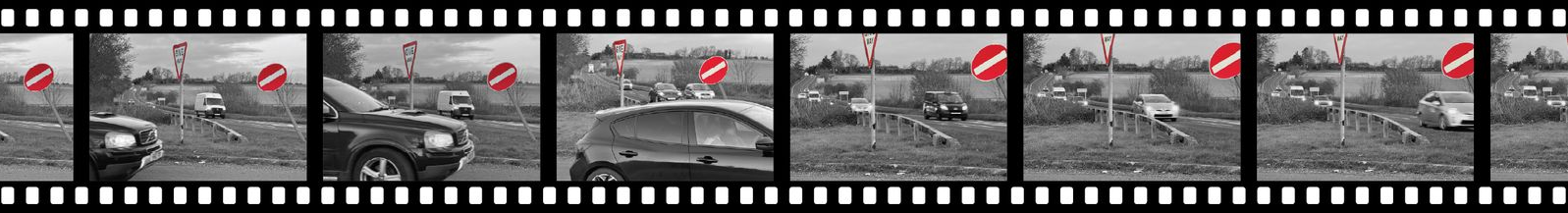Filmstrip with black and white footage of cars.