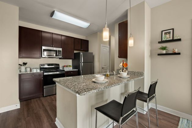 Open kitchen with modern features and stainless steel appliances.