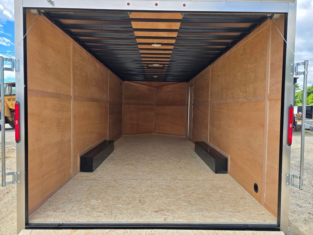Intérieur de remorque de chargement vide avec parois et plancher en contreplaqué, garniture noire.