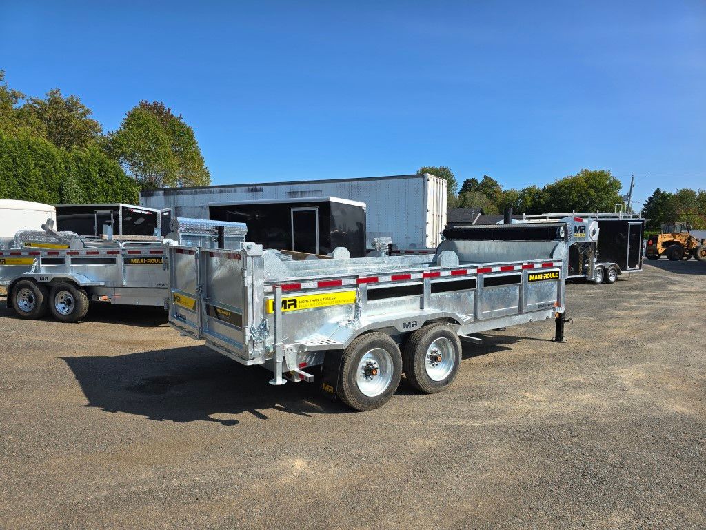 Plusieurs remorques argentées stationnées à l'extérieur par une journée ensoleillée.