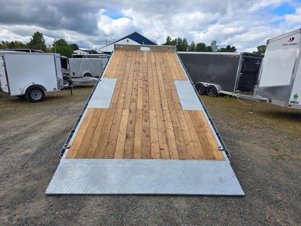Remorque plateau avec plancher en bois, rampes métalliques, extérieur.