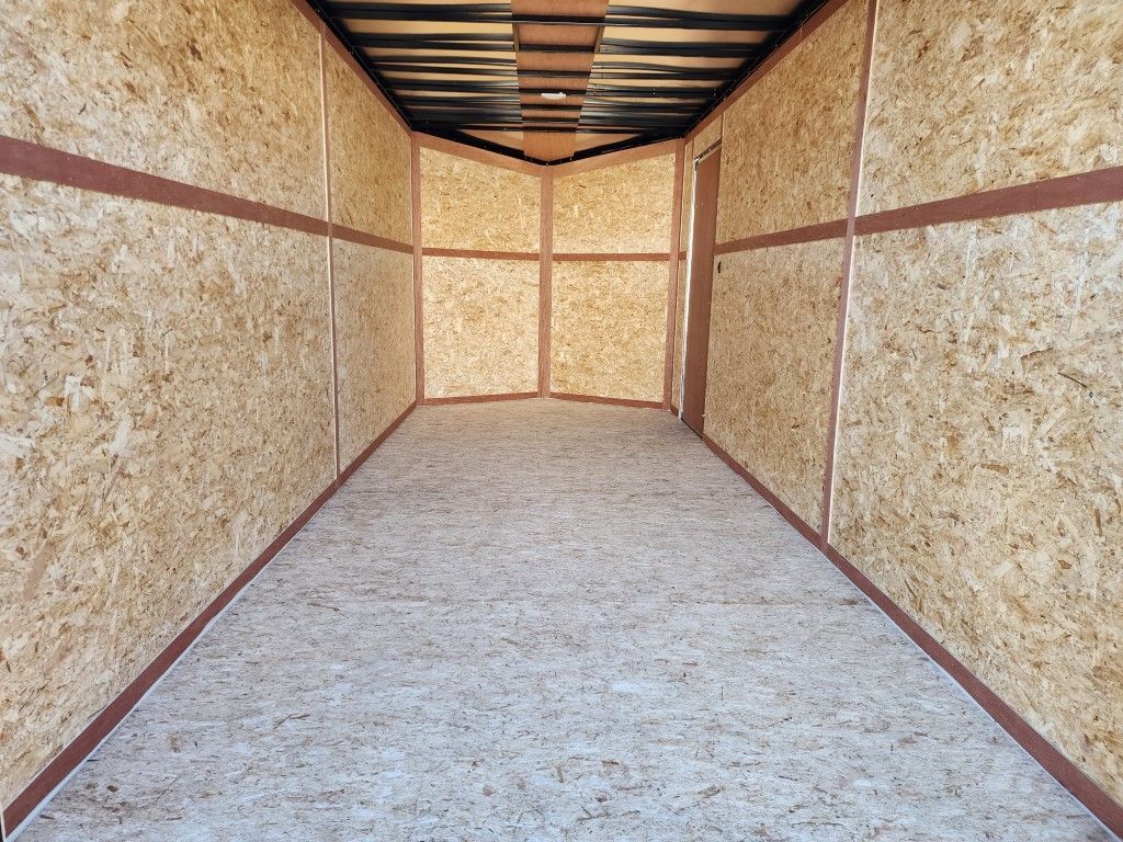 Un long couloir avec un sol recouvert de moquette et des murs en bois