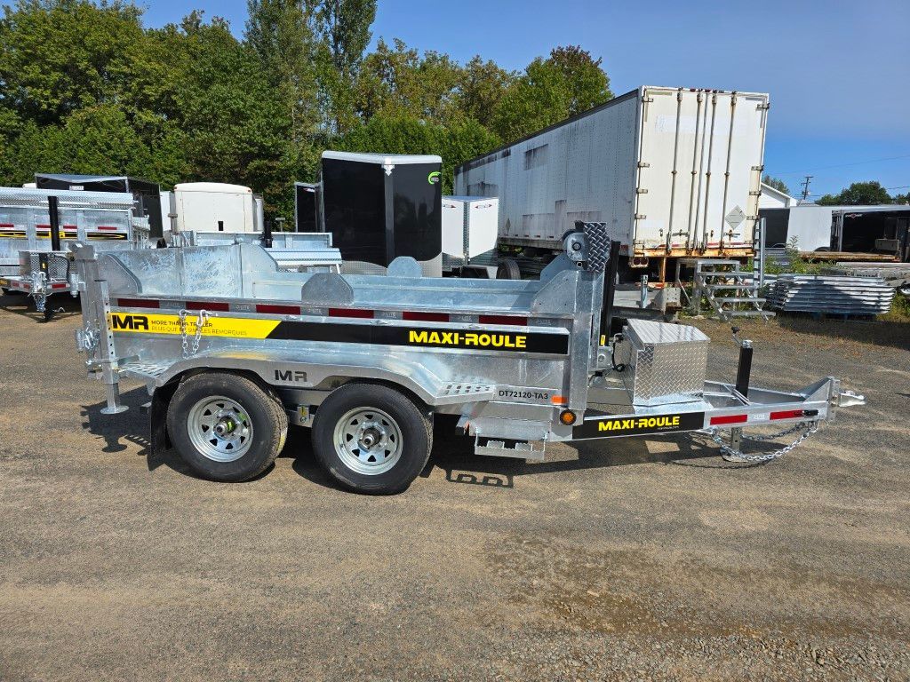 Une remorque à benne basculante est garée sur un parking à côté d'une remorque blanche.