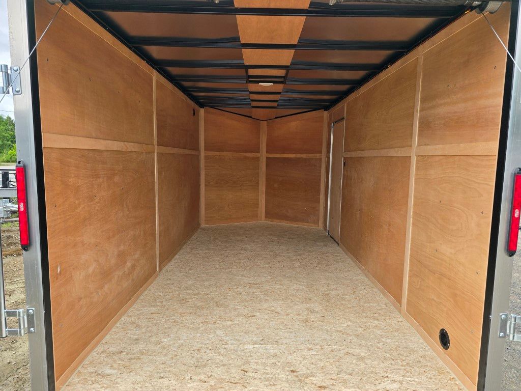 L'intérieur d'une remorque vide avec des parois en bois et un cadre en métal.