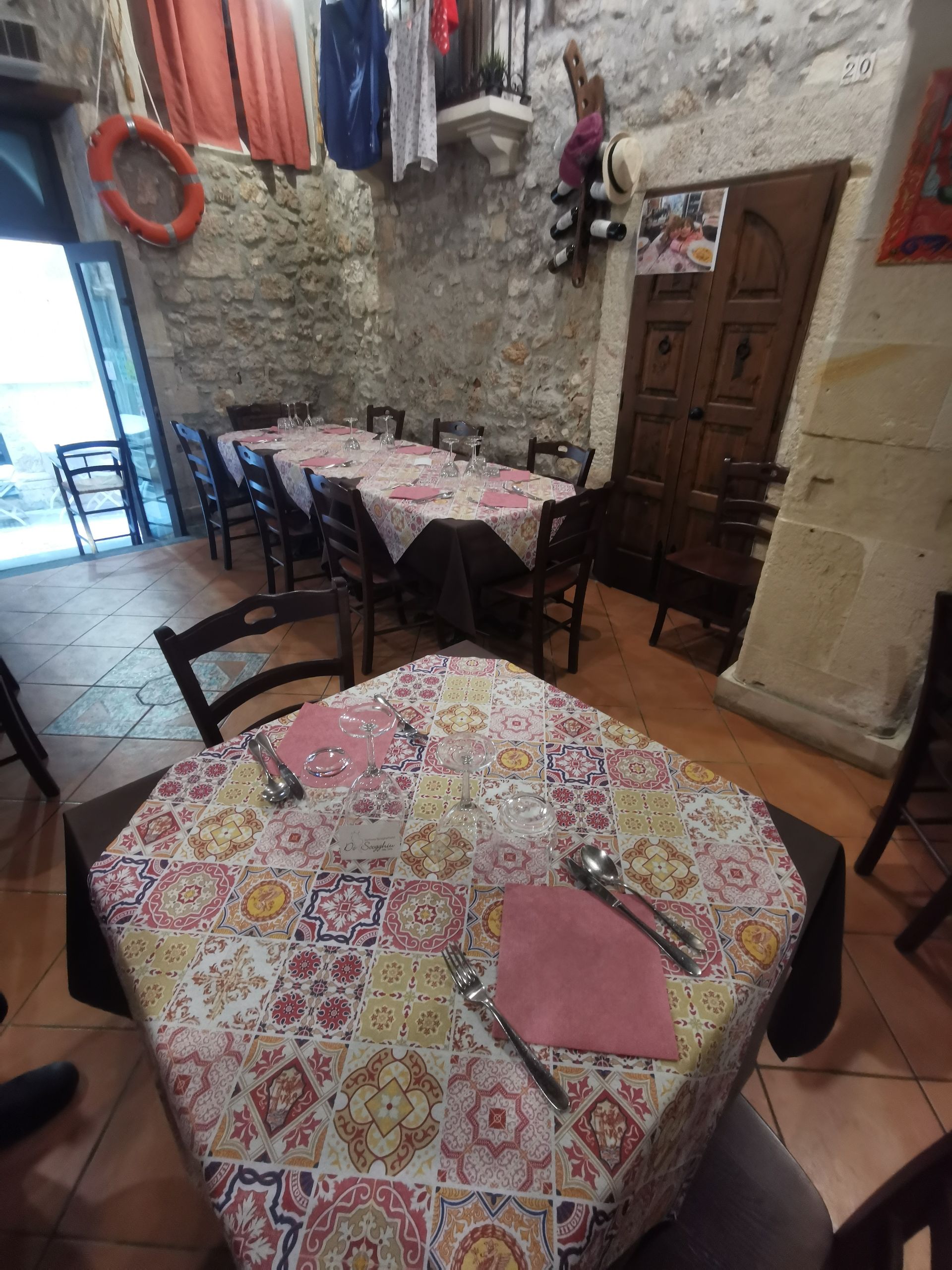 Una sala da pranzo con tavoli e sedie e un tovagliolo rosa sul tavolo
