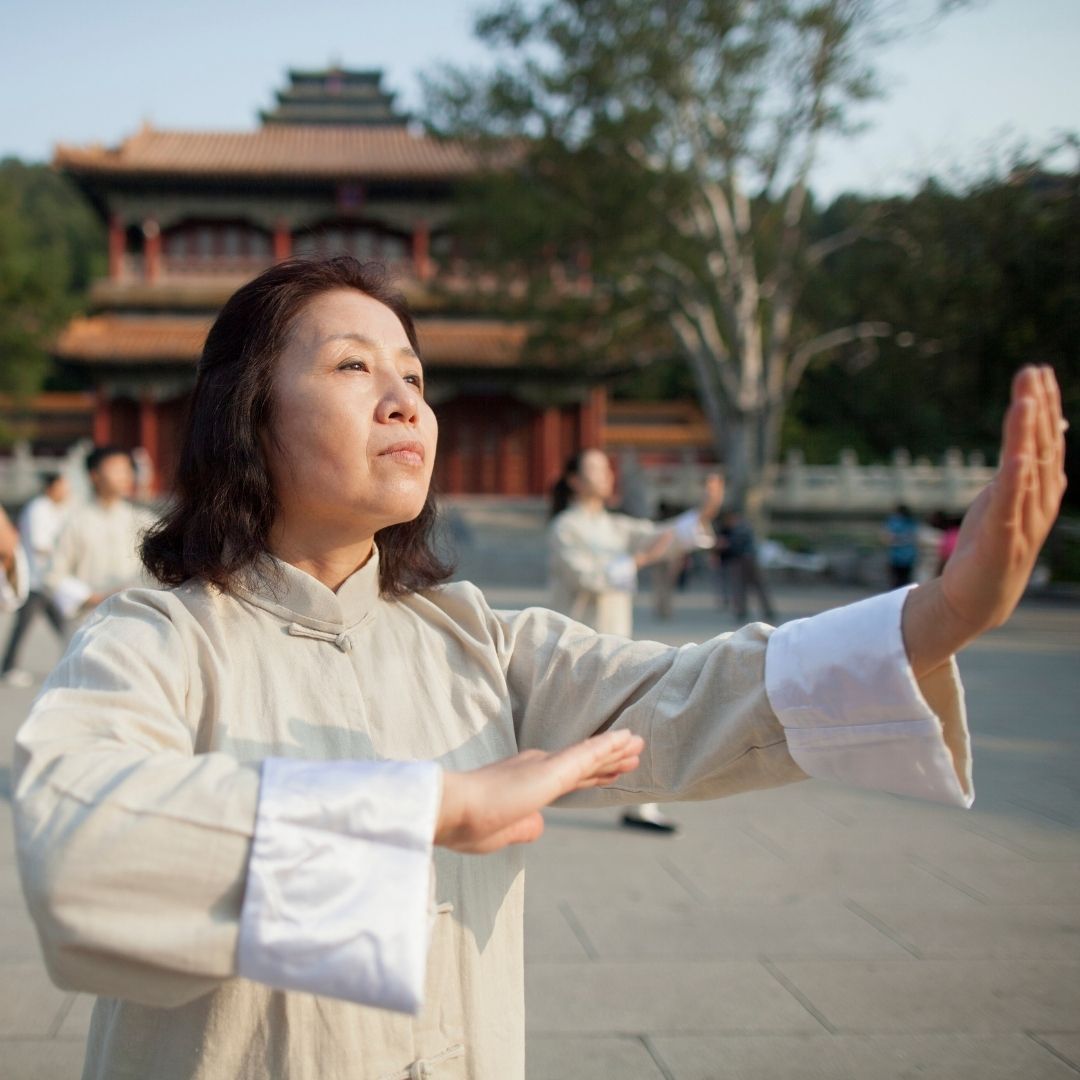 Four men in athletic gear, posing for a photo in a gym.