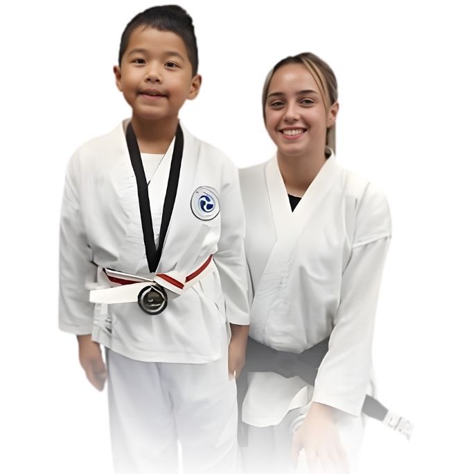 Man pointing, smiling, wearing black hoodie; arm tattoo visible.