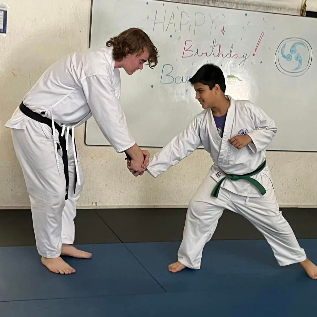 Four men in athletic gear, posing for a photo in a gym.