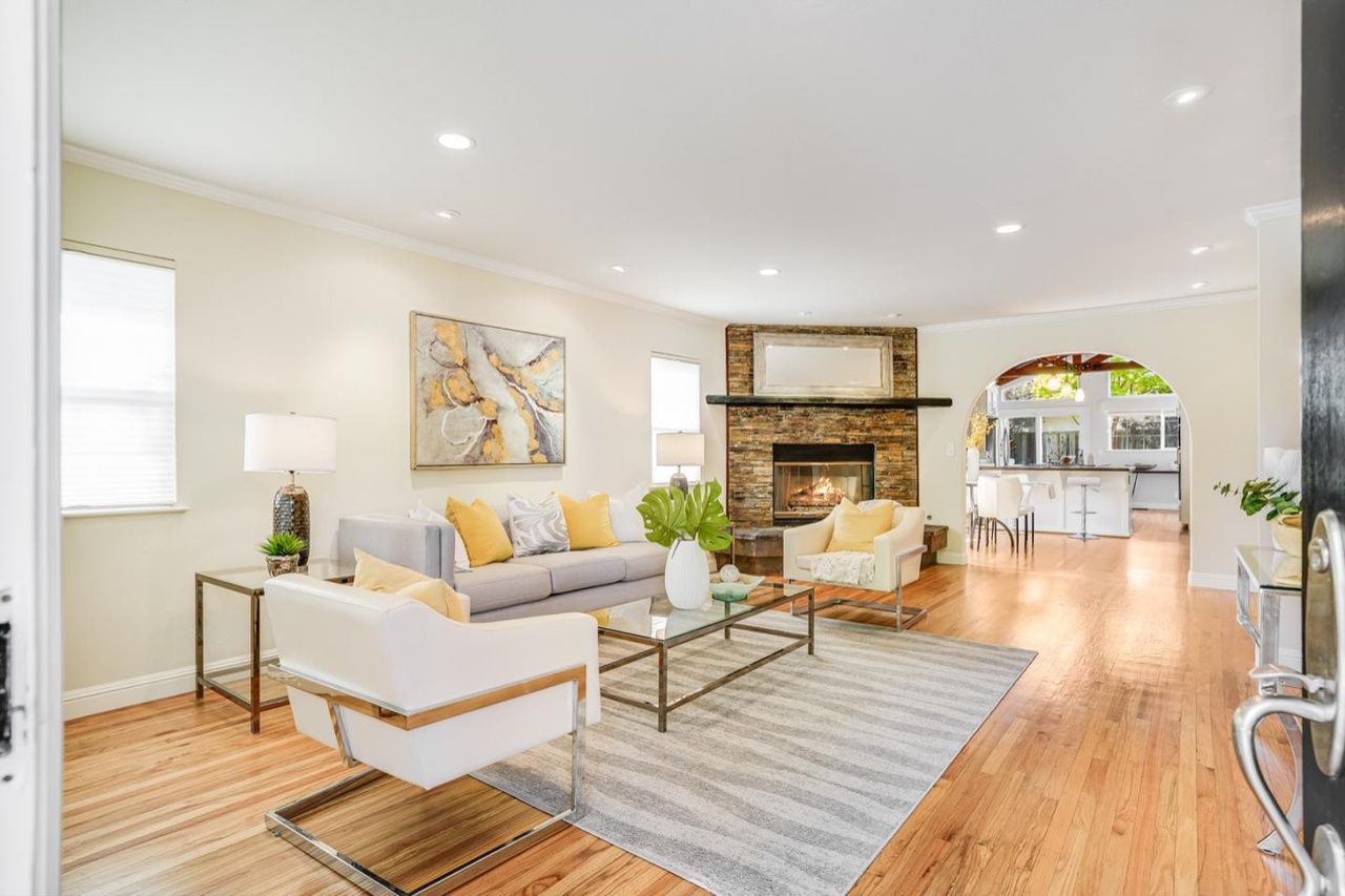 A living room filled with furniture and a fireplace.