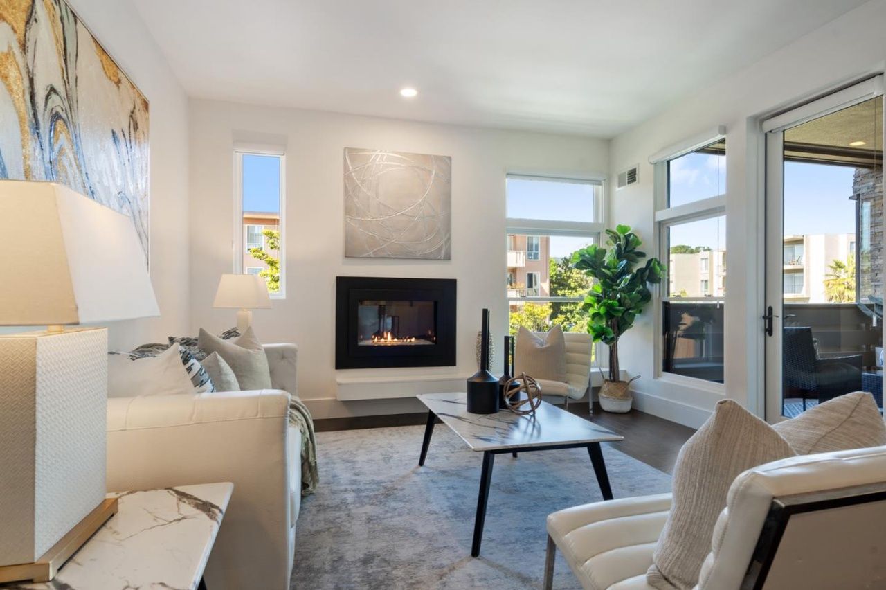 A living room filled with furniture and a fireplace.