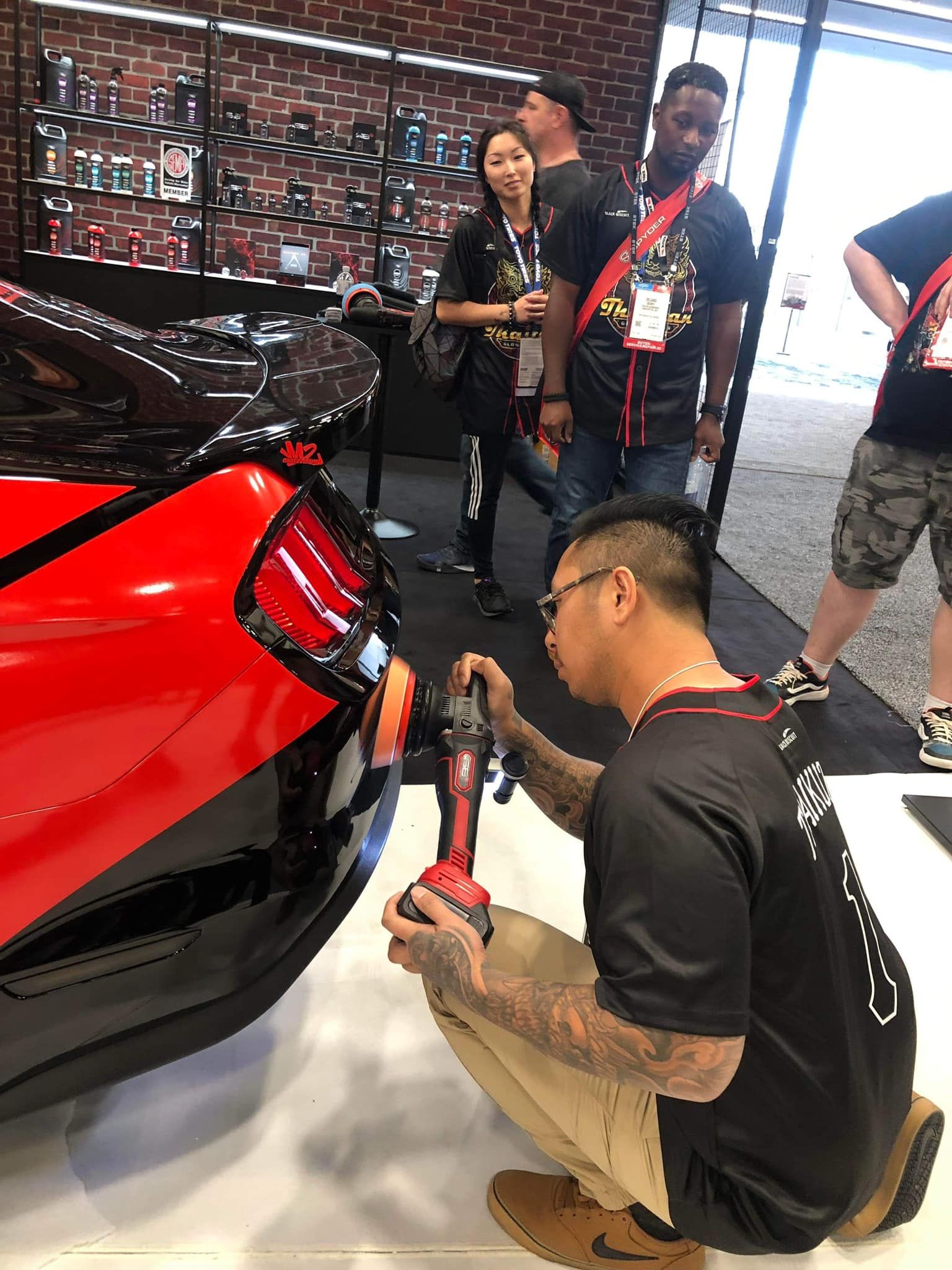A man is cleaning the side of a boat.