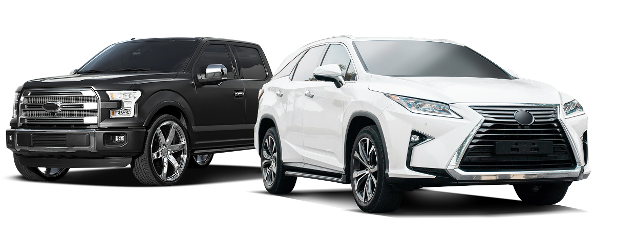 Black pickup truck next to a white SUV on a white background. | Prestige Tire & Auto