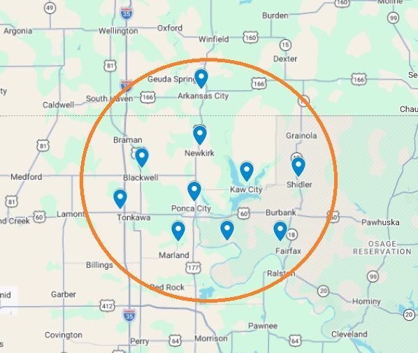 Map showing an orange circle centered on Ponca City, Oklahoma, containing several blue pins for local tree service locations.