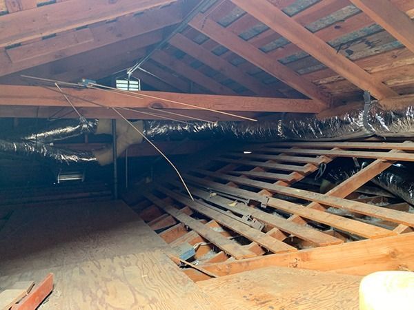 There is a lot of wood in the attic of a house.