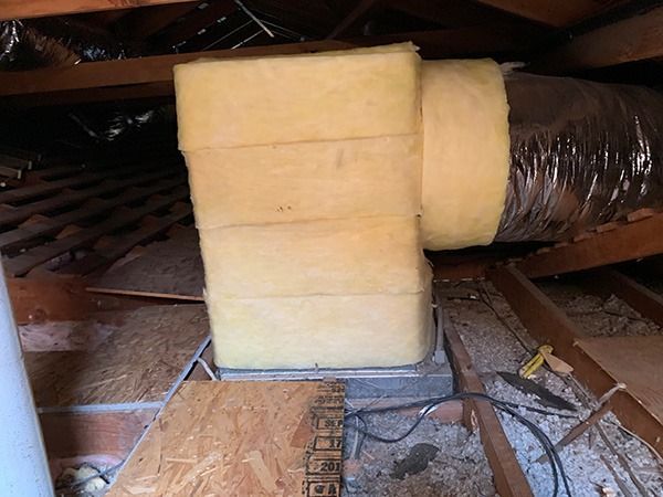 There is a duct in the attic with insulation on it.