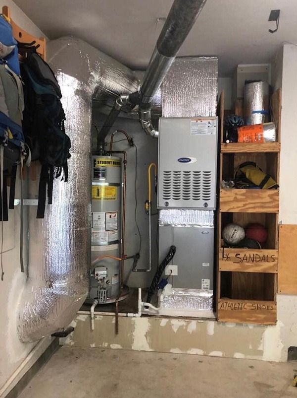 A room with a carrier heater and a water heater in it