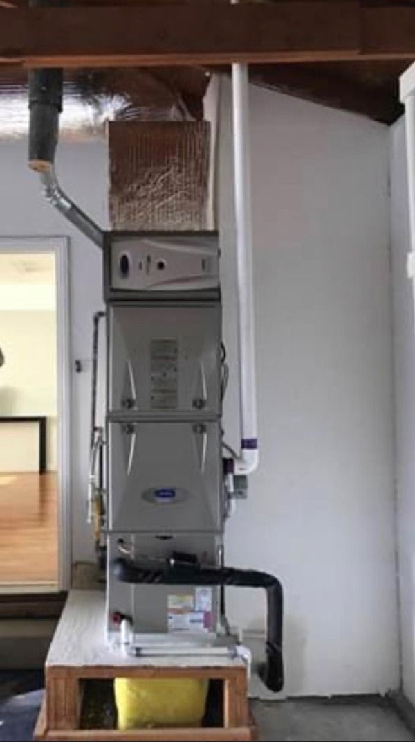 A picture of a Carrier furnace in a room.