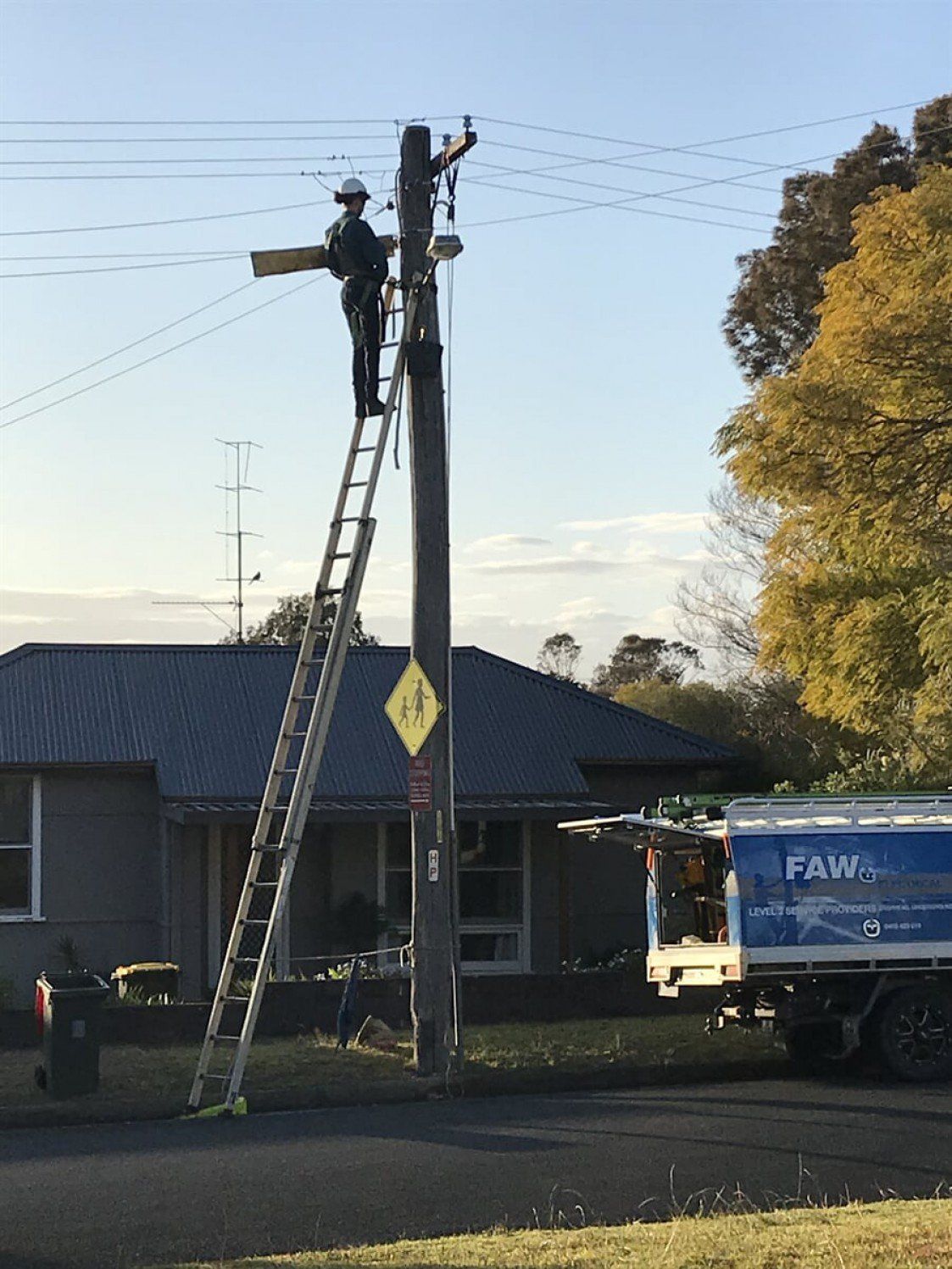 Electrician On A Residential Post — FAW Electrical in Nowra Hill, NSW