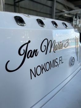 The name jan marie is on the side of a boat