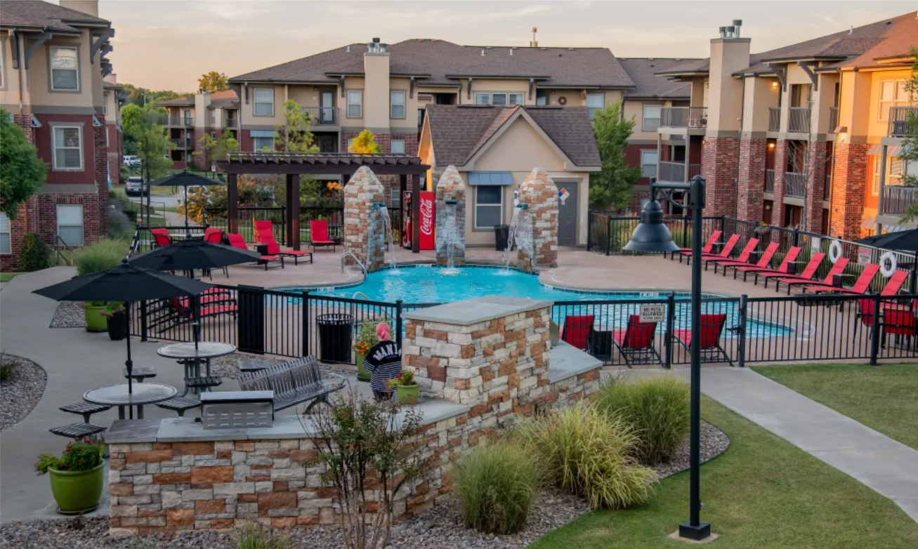 Zoomed Out Photo Showing Pool Area And Apartments