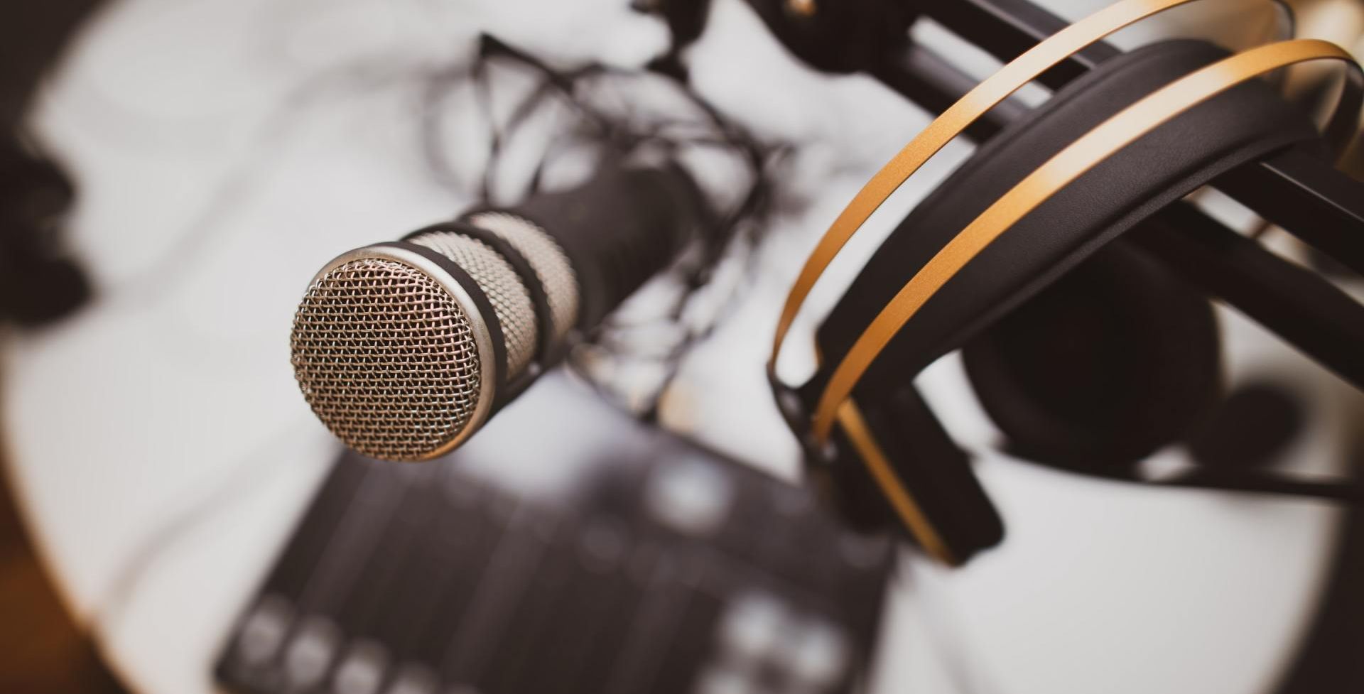 A close up of a microphone and headphones on a table.