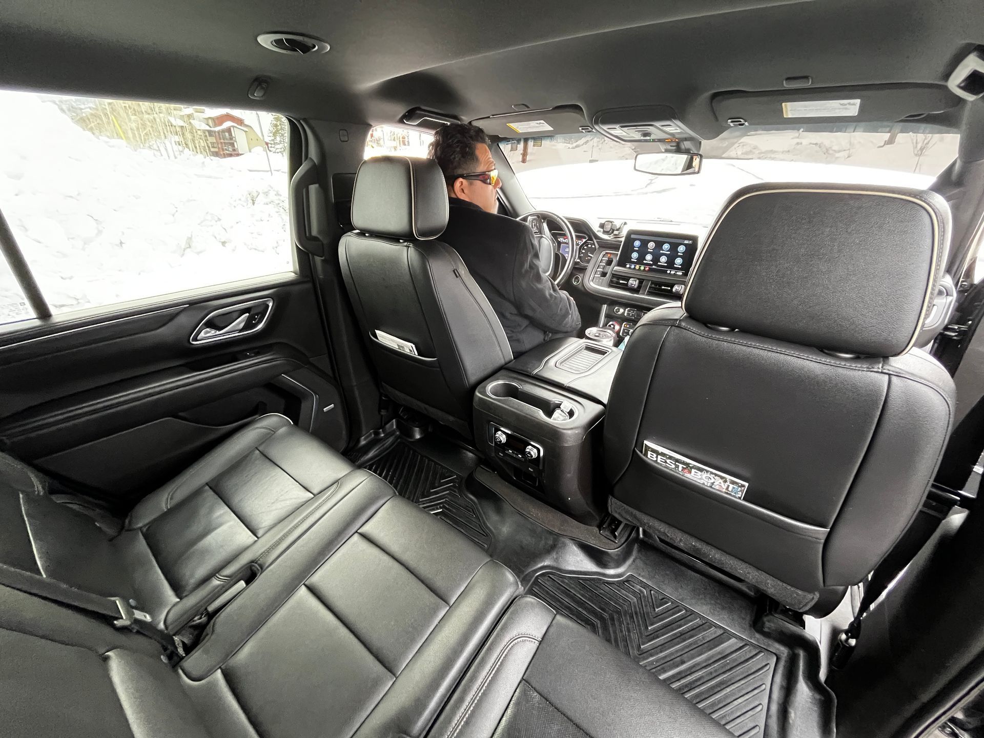 A man is sitting in the driver 's seat of a car.