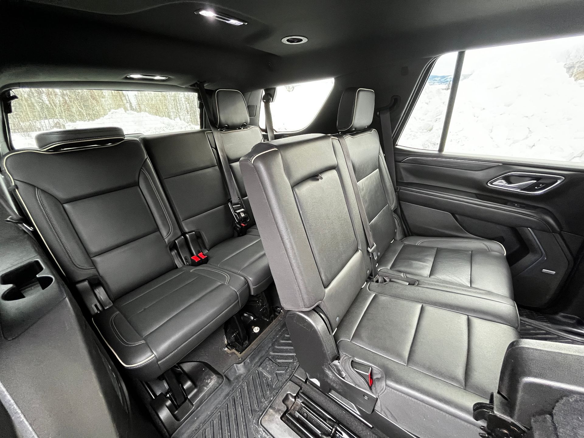 The rear seats of a ford expedition are folded down.